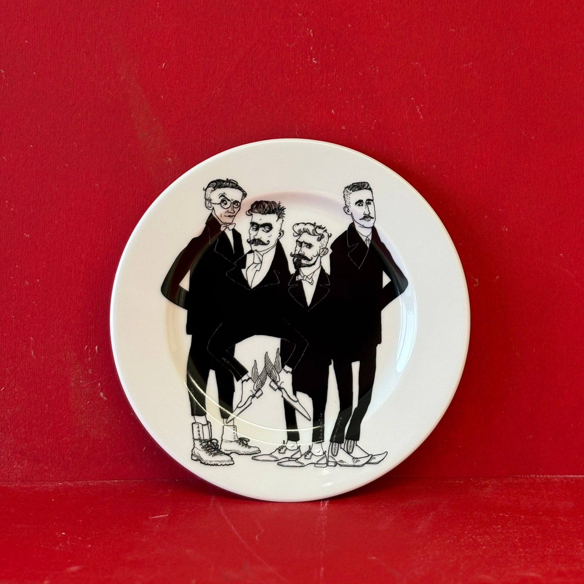 Small round plate with black and white illustration of four men on a red background