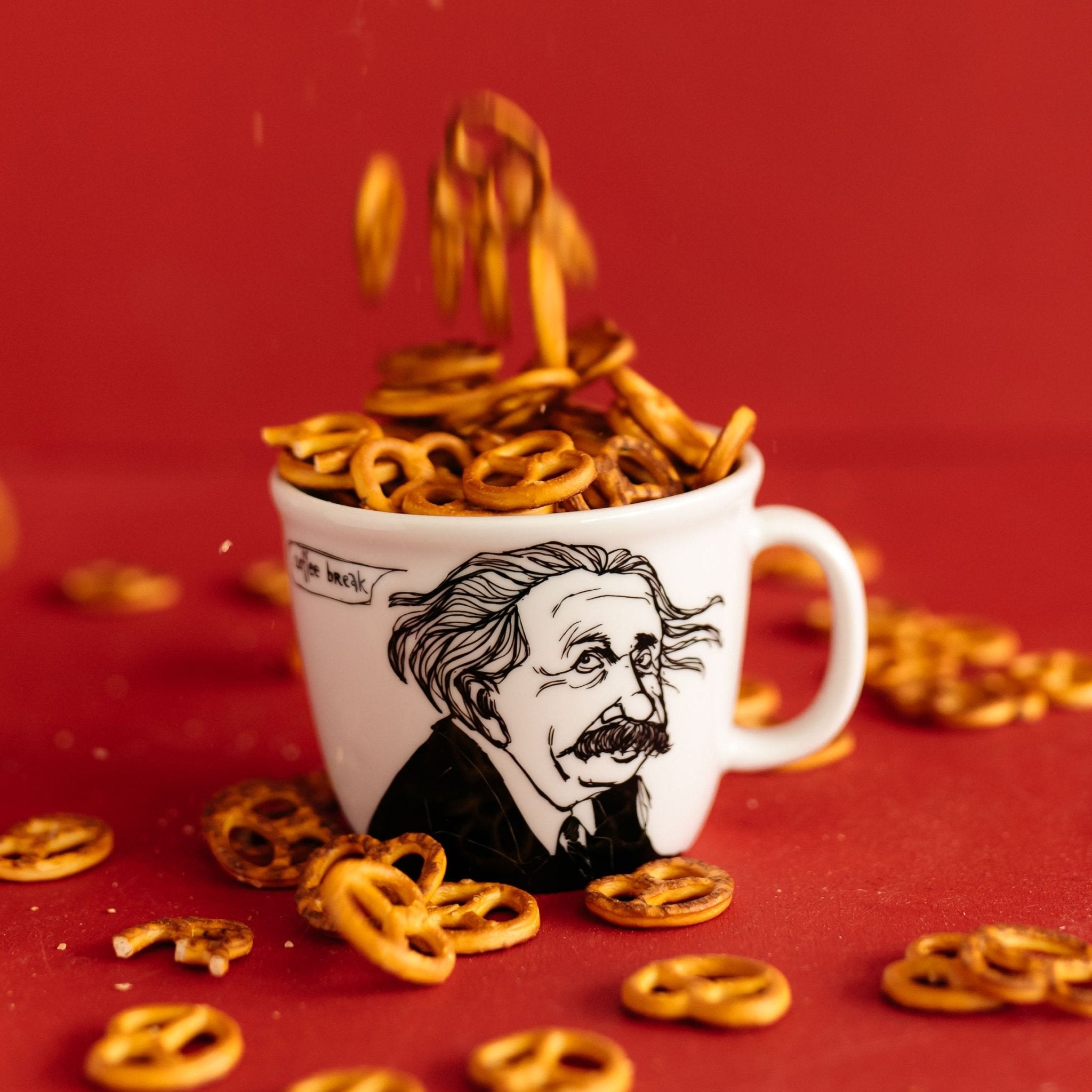 Porcelain cup inspired by Albert Einstein with pretzels