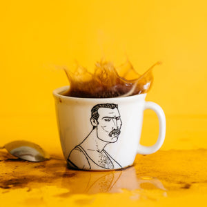 Porcelain cup inspired by Freddie Mercury with a splash of coffee