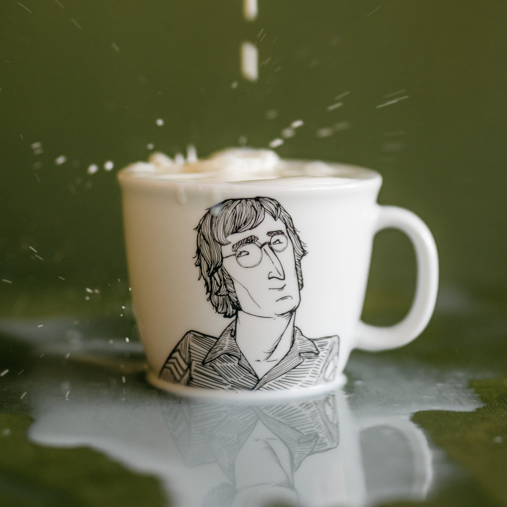 Porcelain cup inspired by John Lennon with a splash of milk