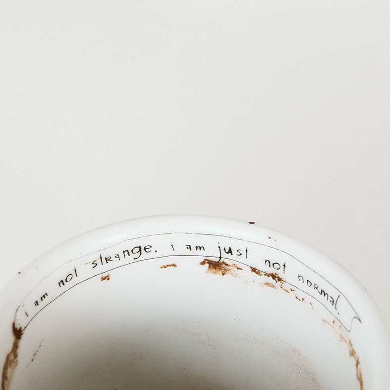 Porcelain cup inspired by Salvador Dali text inside of the cup
