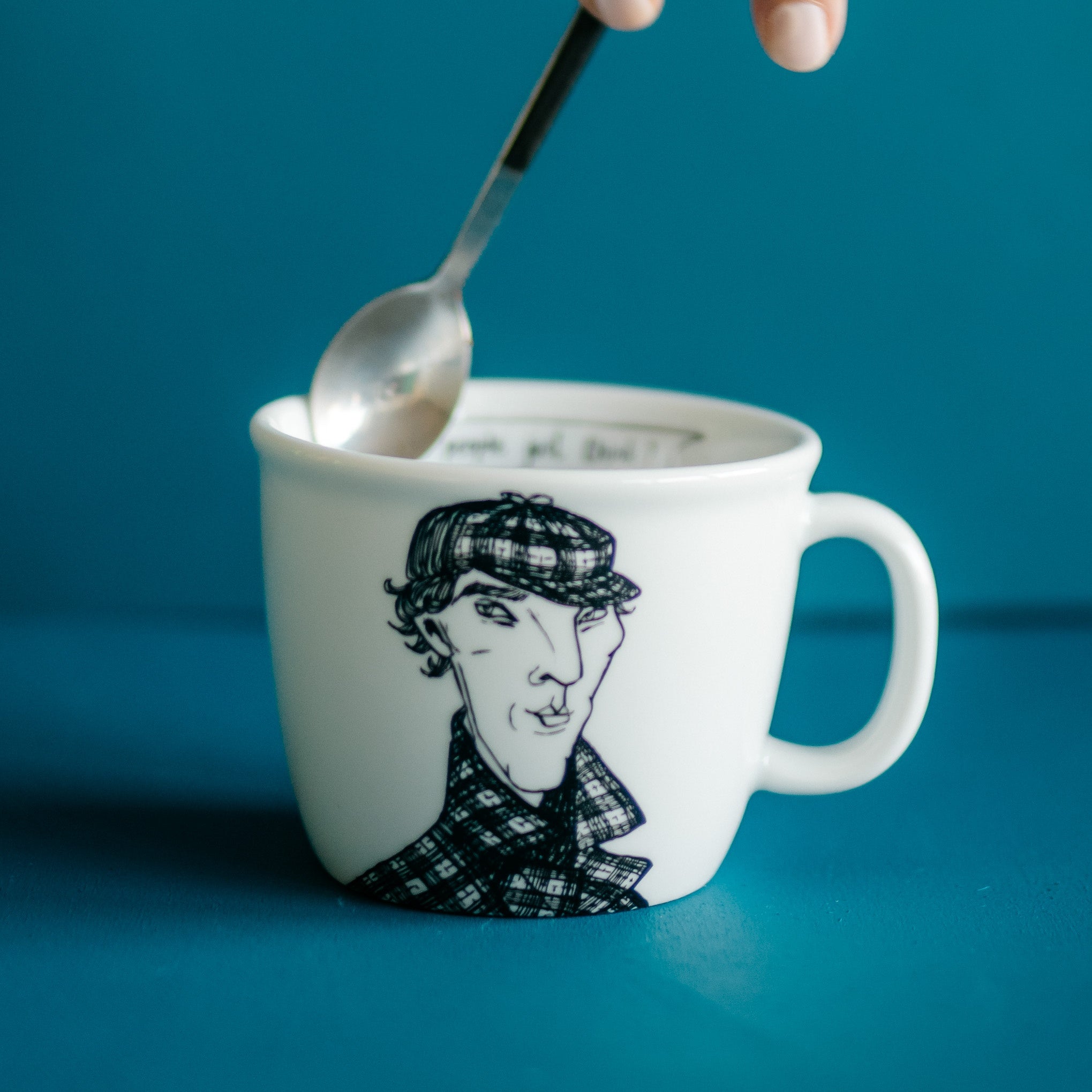 Porcelain cup inspired by Sherlock Holmes with a spoon