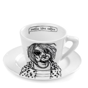 porcelain cup and saucer with a black and white illustration of a person and text 'smells like coffee' on a white background.