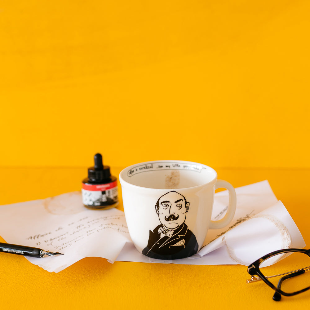 This image features a stylish ceramic mug with a unique design, appealing to fans of the classic detective genre. Set in a yellow background with old fashioned handwriting on paper. The mug is predominantly white with a detailed black illustration of Hercule Poirot, the famous Belgian detective, donned in his signature mustache and detective attire.