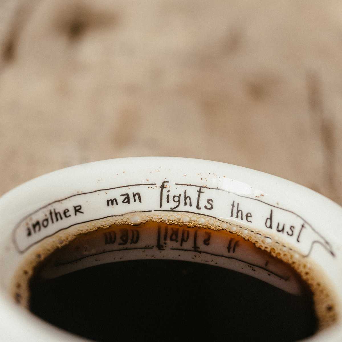 “another man fights the dust” text on the edge of the FREDDIE cappuccino set